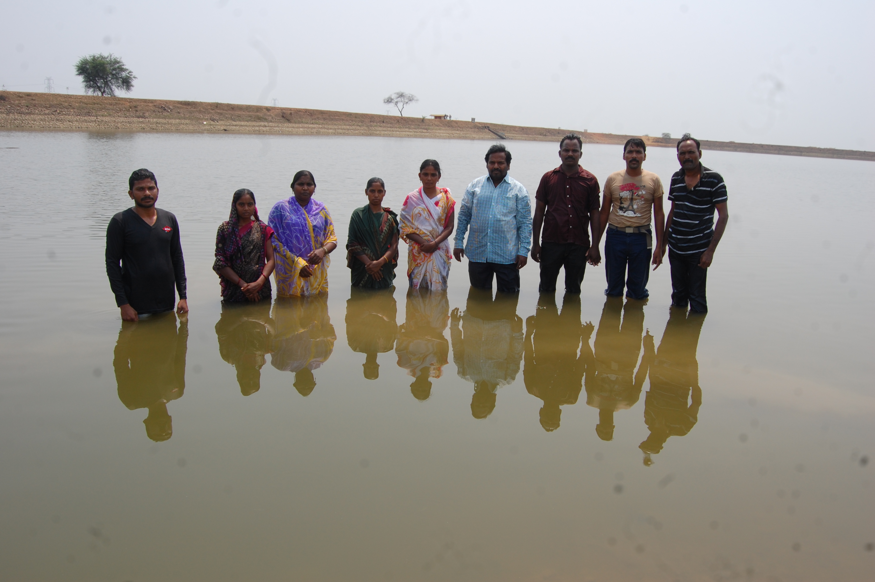 Newly baptized believers in a river group photo