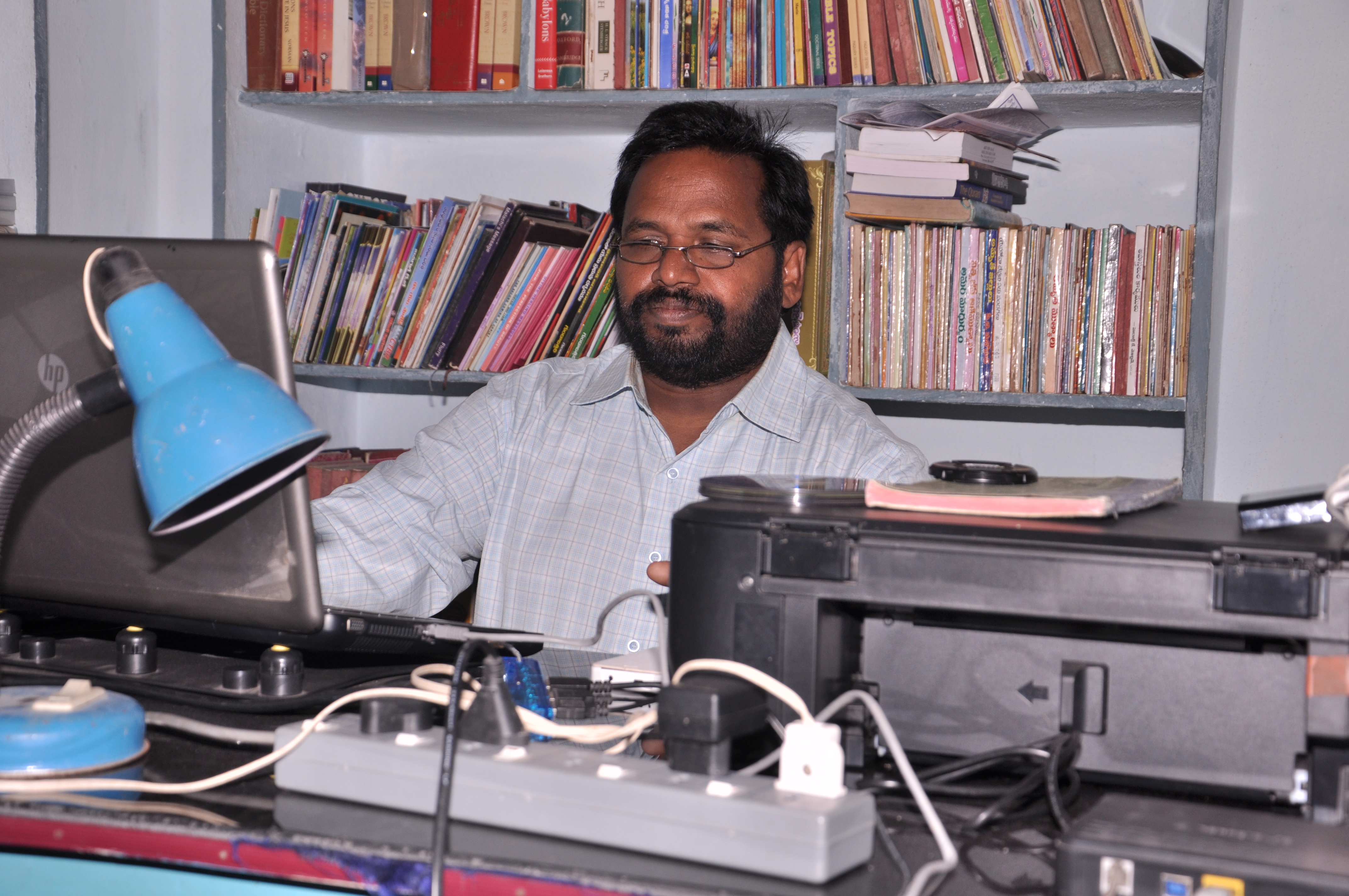 Brother Isaac E. Kusuma working as Chief Editor of gospel publications