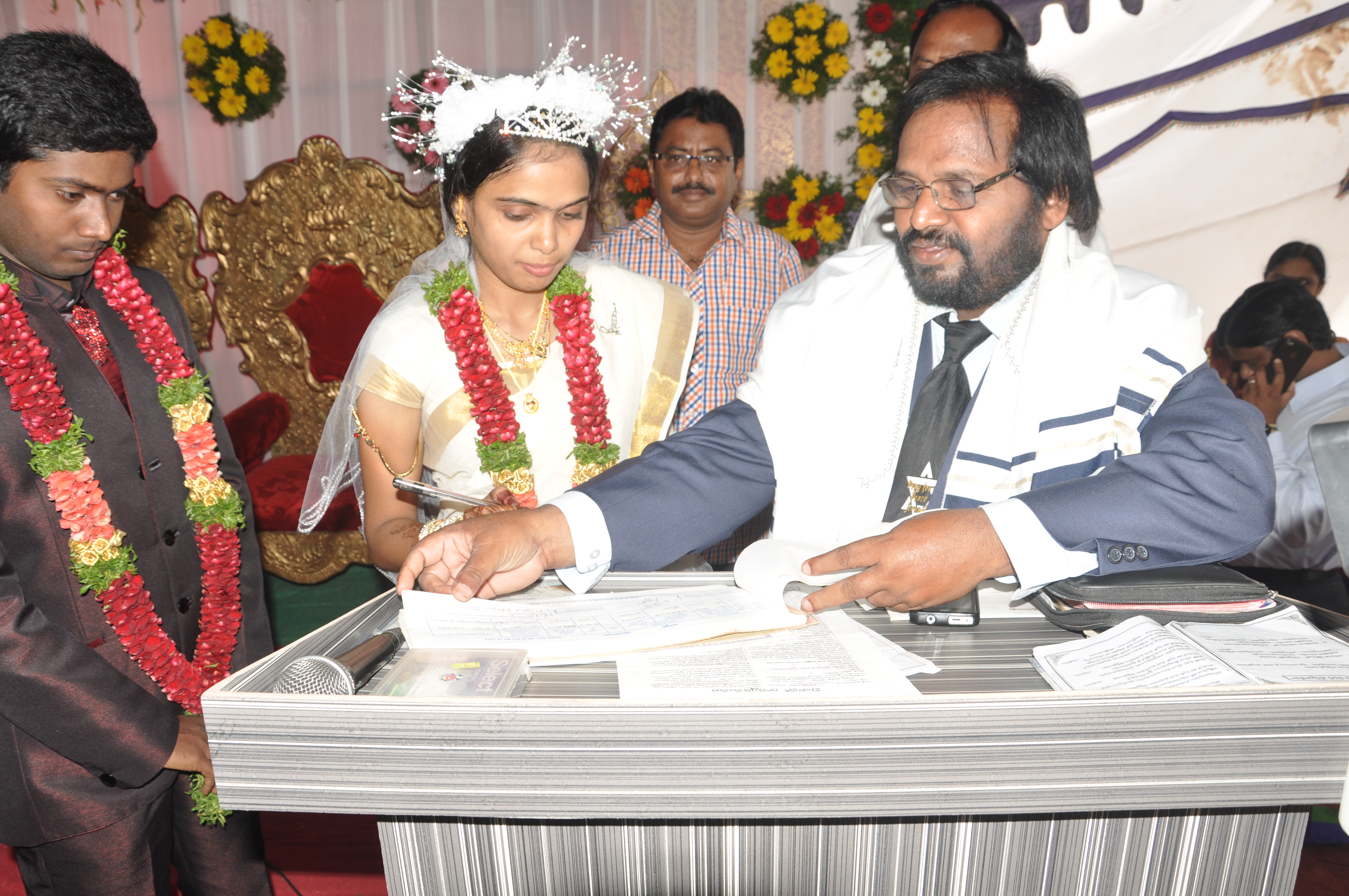Brother Isaac officiating and registering a marriage